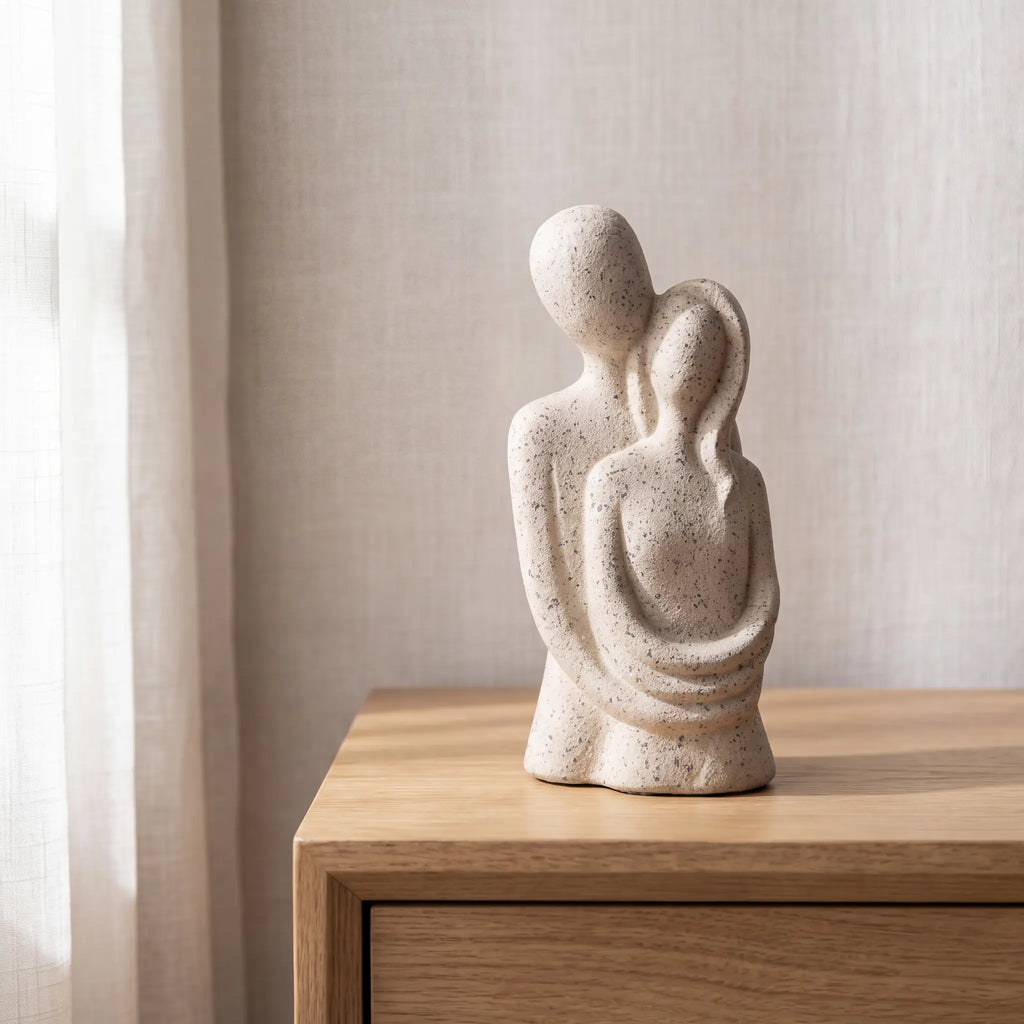 Escultura casal abraçado em criado-mudo com cortina de linho claro