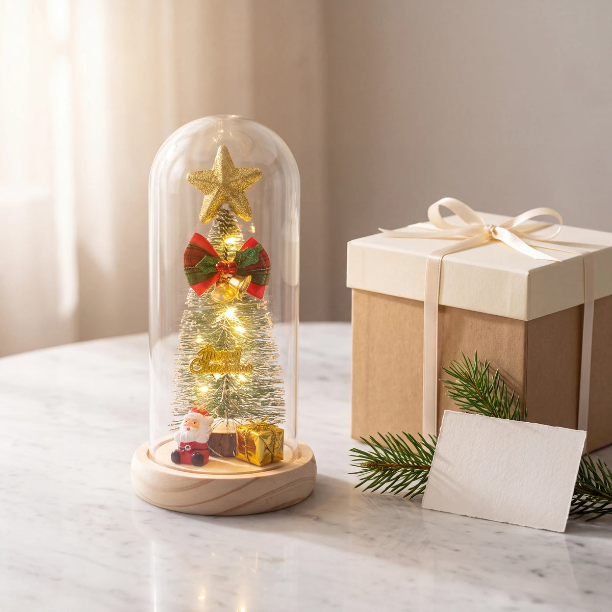 Luminária de Natal ao lado de caixa de presente bege com ramo de pinheiro sobre mármore branco